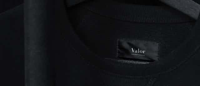 T-shirt mockup of the Valor logo, black background and high quality